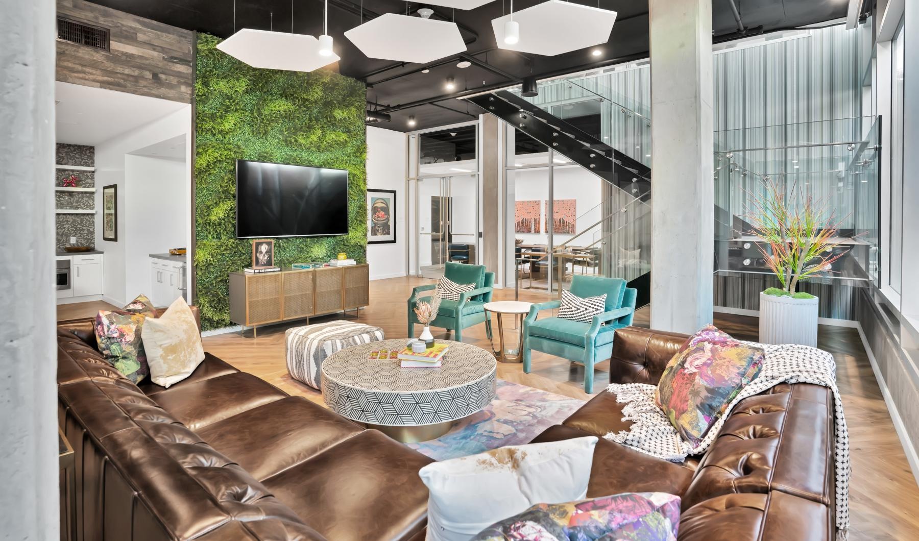 The essence of exceptional living lounge area with leather couch, coffee table and mounted tv