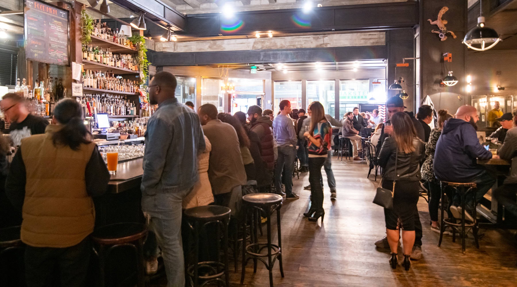 Vibrant Community Life group of people standing around at a bar