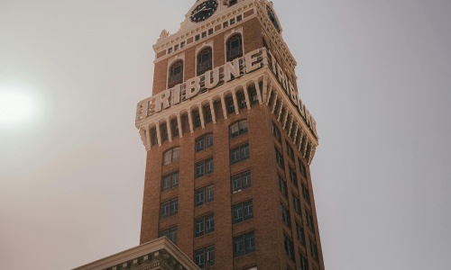 Low angle shot of brick clock tower of the tribune in Oakland
